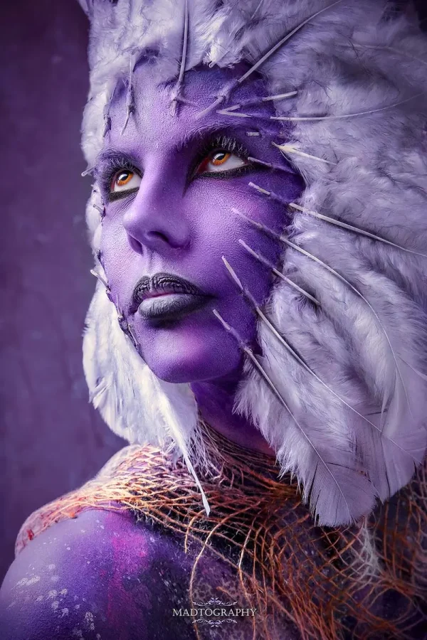 face pierced with feathers bodypainting photo madtography